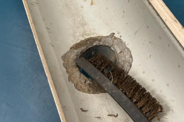Clean out downpipe outlet with wire brush